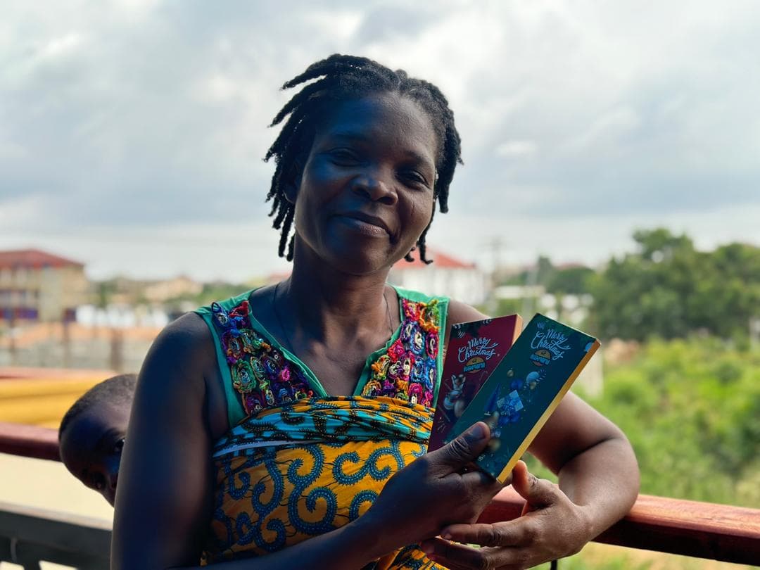 Ghanaian woman holding Kamini chocolates